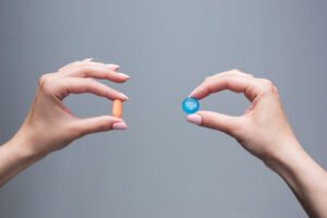 image of two women holding viagra vs cialis pills